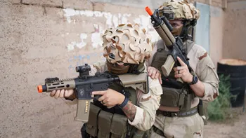 Two men in airsoft gear carrying Elite Force Airsoft Guns