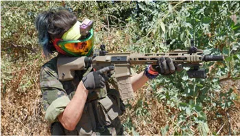 AIrsoft player shooting their carbine in a match